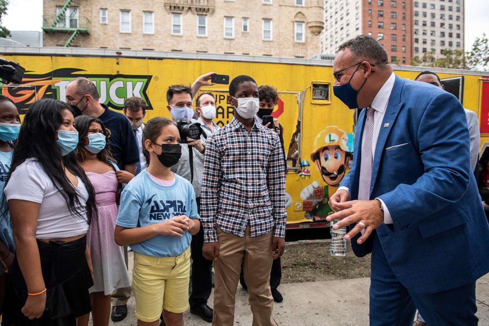 Education Secretary Miguel Cardona speaks to students outside P.S. 5 Port Morris, a Bronx elementary school in New York on Aug. 17, 2021.