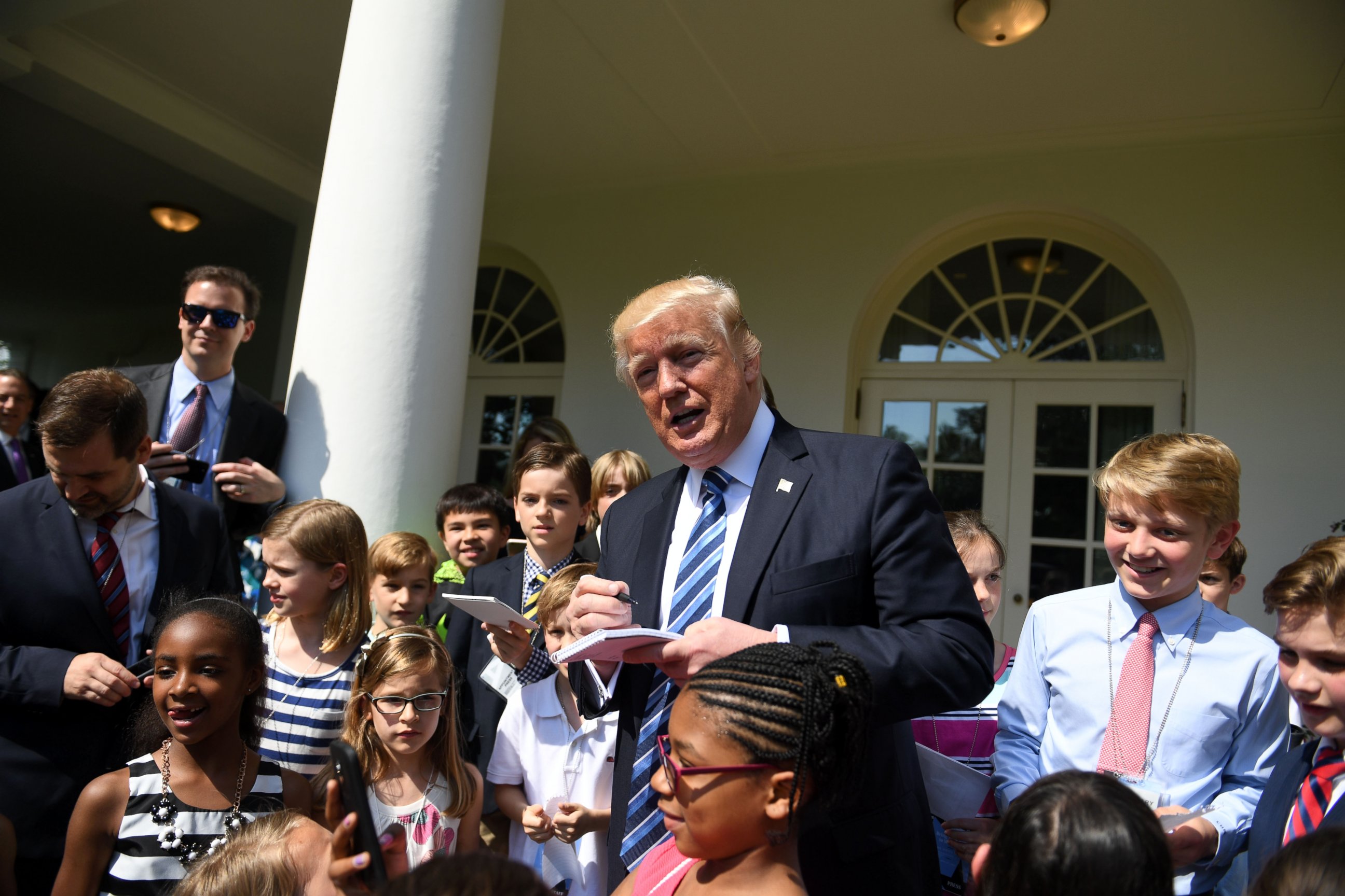 PHOTO: U.S. President Donald Trump signs autographs for children of White House staffers and reporters during "Take Our Daughters and Sons to Work Day" at the White House in Washington, on April 27, 2017.