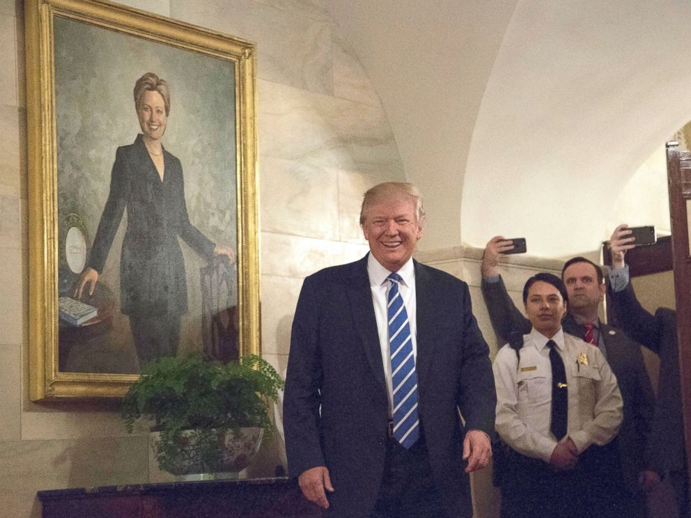 PHOTO: President Donald Trump greets the first new visitors in the Center Hall of the Ground Floor of the White House, in front of the official portrait of former first lady Hillary Clinton, Washington, March 7, 2017.