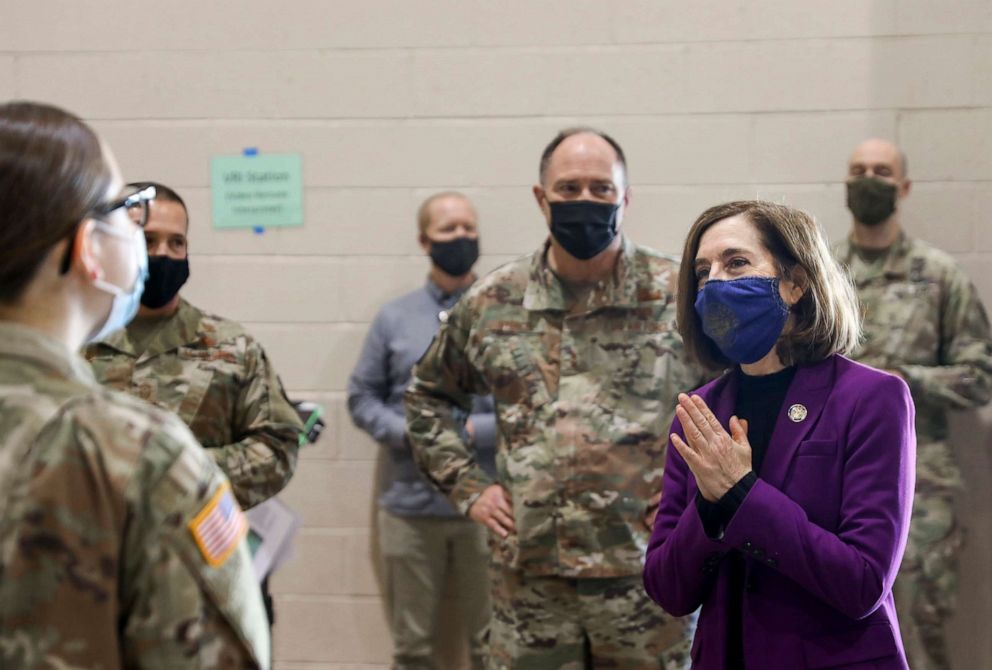 PHOTO: Oregon Gov. Kate Brown visits with National Guard members at the Marion County and Salem Health COVID-19 vaccination clinic, Jan. 13, 2021, at the Oregon State Fairgrounds in Salem, Ore.
