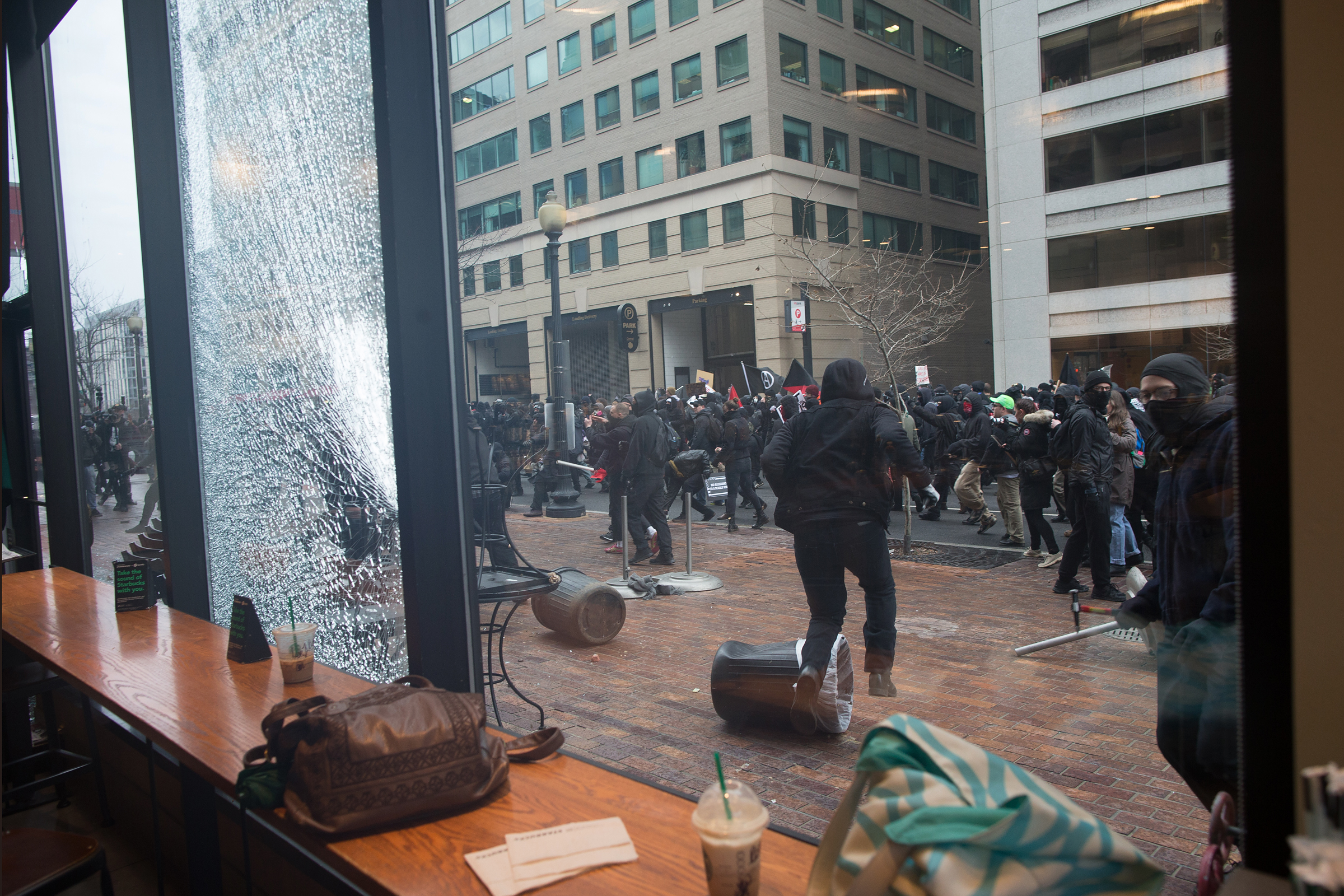 PHOTO: Anti Trump protestors hurled rocks and other debris at the Starbuck's Cafe window as they ran through the streets, on Jan. 20, 2017, in Washington.