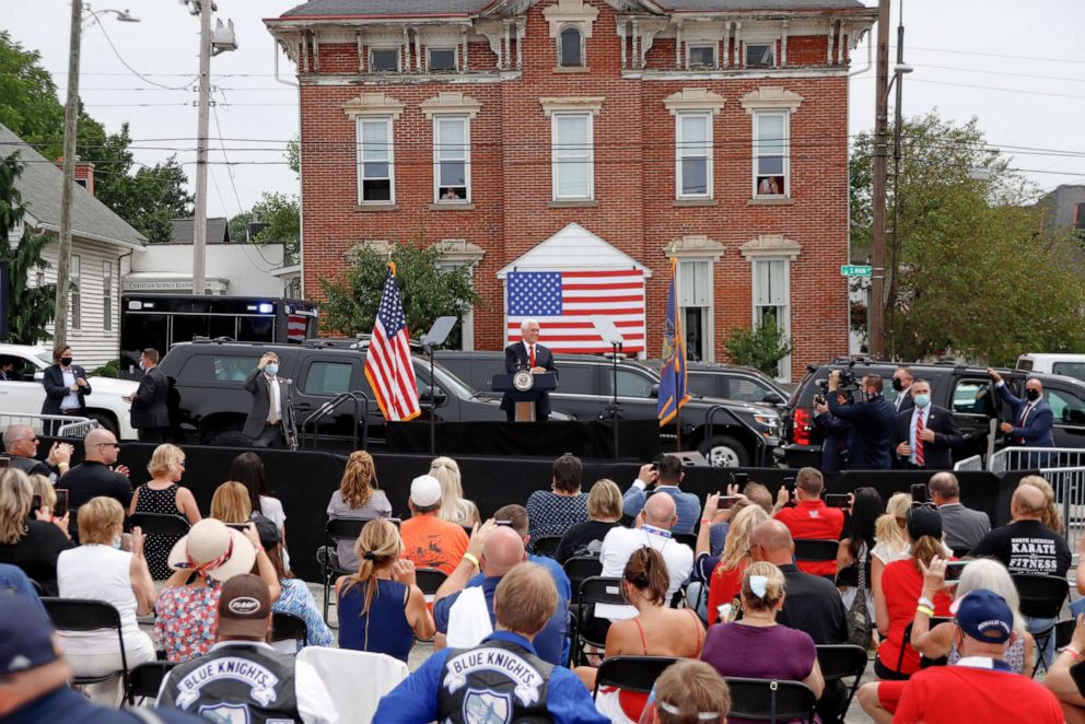 PHOTO: Supporters cheer and take pictures as Vice President Mike Pence speaks at a "Cops for Trump" campaign event at the police station, July 30, 2020, in Greensburg, Pa. 