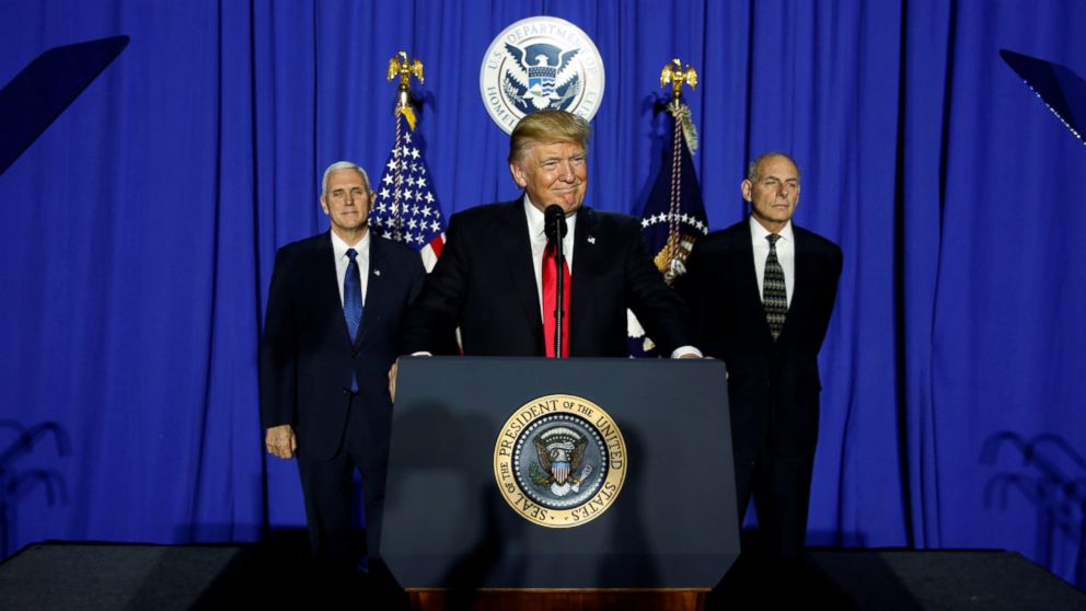 U.S. President Donald Trump (C), flanked by Vice President Mike Pence (L) and Homeland Security Secretary John Kelly (R), takes the stage to deliver remarks at Homeland Security headquarters in Washington, Jan. 25, 2017.  