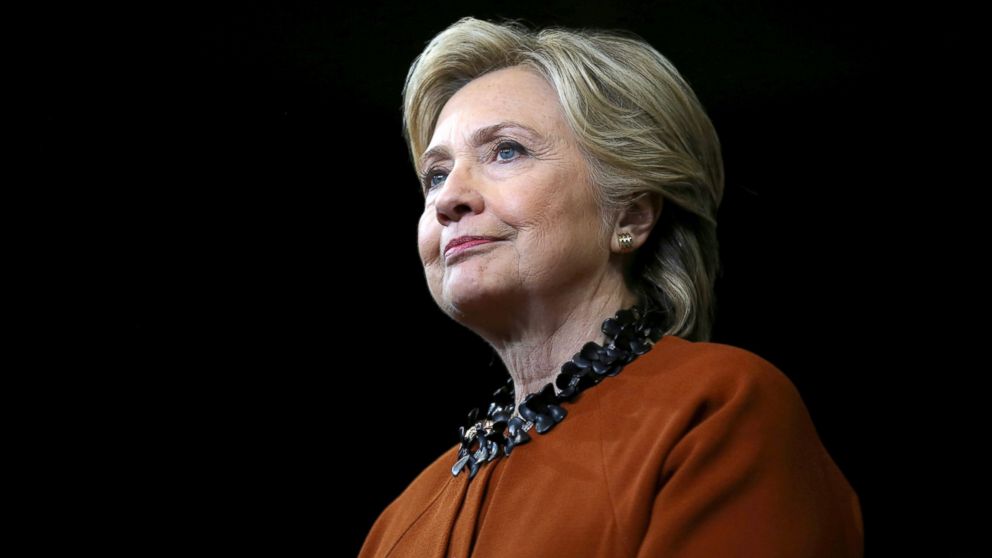 Democratic presidential candidate Hillary Clinton listens as First Lady Michelle Obama (not pictured) speaks during a campaign rally in Winston-Salem, North Carolina, Oct. 27, 2016.
