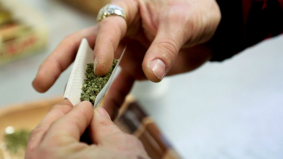 A customer rolls a joint in Seattle, April 20, 2014. 