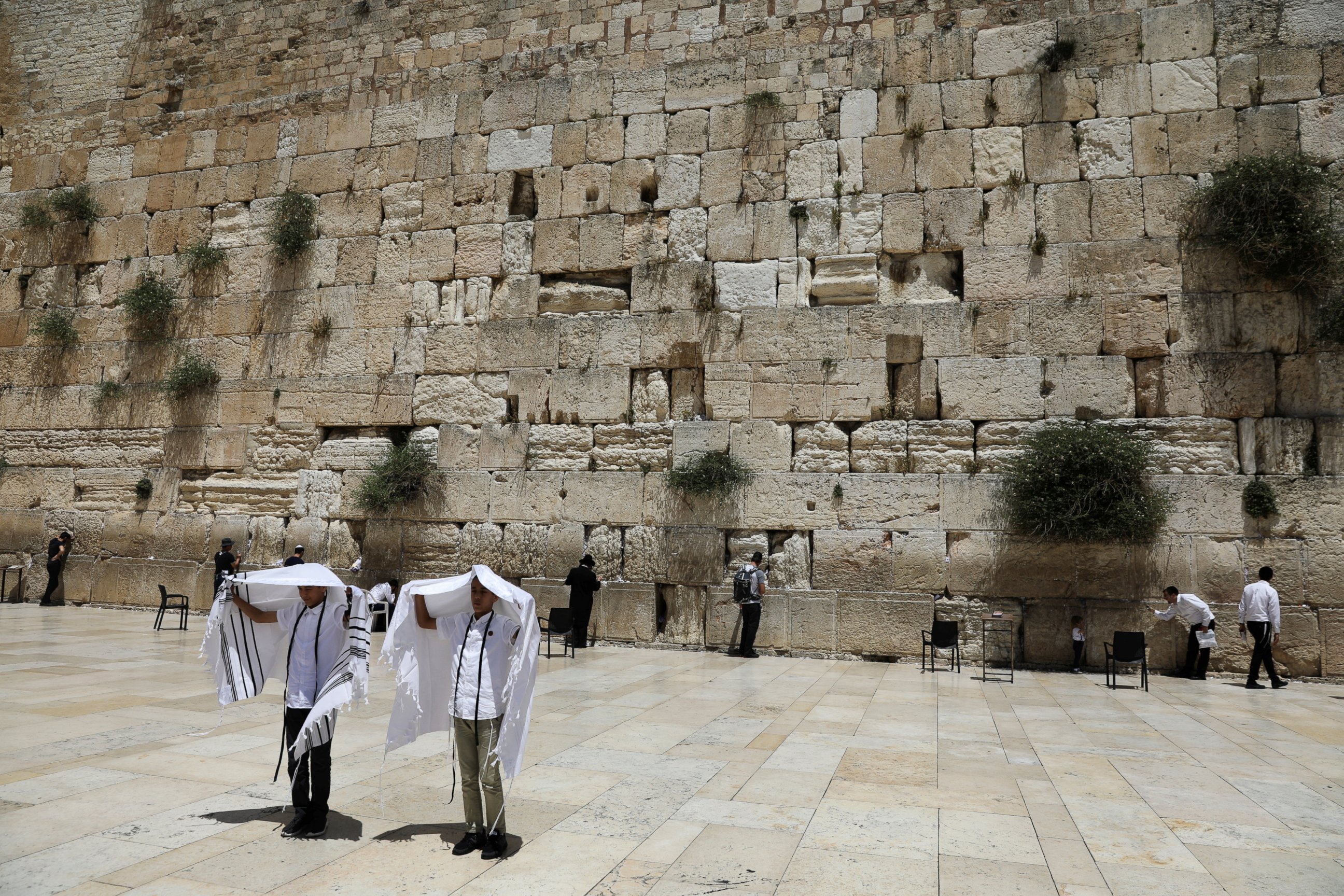 PHOTO: Youth hold their prayer shawls as they stand in front of the Western Wall, Judaism's holiest prayers site in Jerusalem's Old City, May 17, 2017. 
