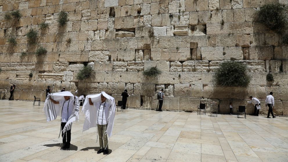 PHOTO: Youth hold their prayer shawls as they stand in front of the Western Wall, Judaism's holiest prayers site in Jerusalem's Old City, May 17, 2017. 