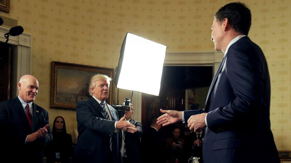 PHOTO: President Donald Trump greets FBI Director James Comey during the Inaugural Law Enforcement Officers and First Responders Reception in the Blue Room of the White House, January 22, 2017.
