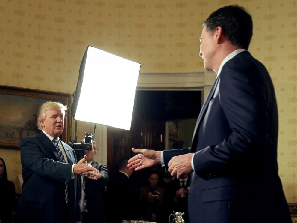 PHOTO: President Donald Trump greets FBI Director James Comey during the Inaugural Law Enforcement Officers and First Responders Reception in the Blue Room of the White House, January 22, 2017.