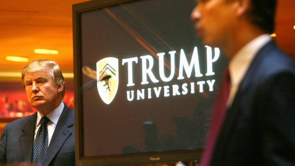 Real estate mogul and TV star Donald Trump listens as Michael Sexton introduces him to announce the establishment of Trump University during a news conference in New York, May 23, 2005.  