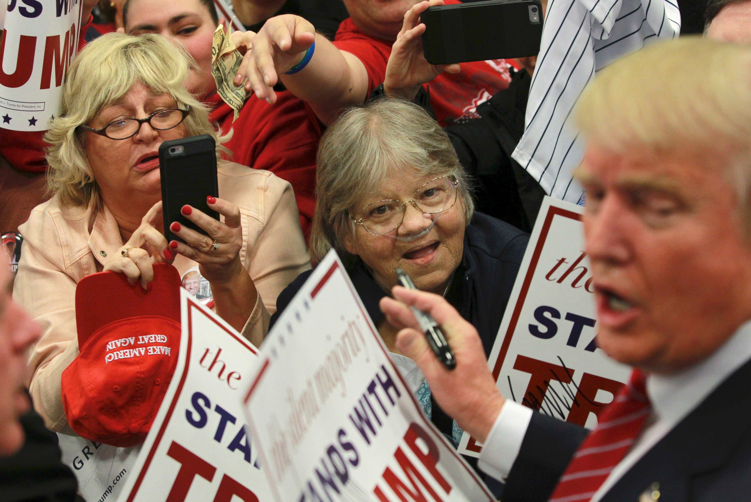 PHOTO: Supporters of Republican U.S. presidential candidate Donald Trump take pictures and seek autographs from Trump (R) at a campaign rally in New Orleans, Louisiana March 4, 2016.   