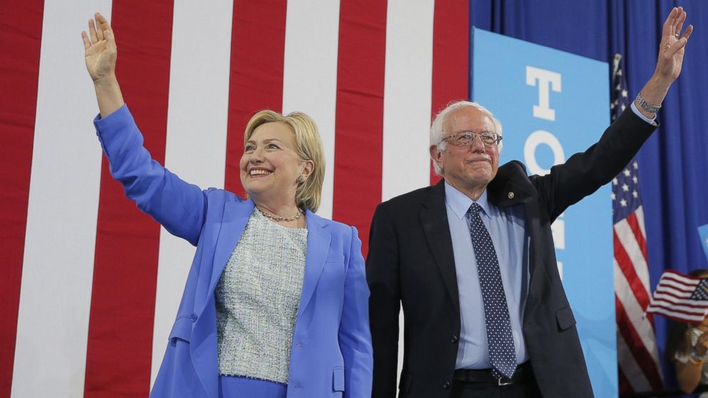Democratic U.S. presidential candidate Hillary Clinton and Sen. Bernie Sanders stand together during a campaign rally where Sanders endorsed Clinton in Portsmouth, New Hampshire, July 12, 2016.  