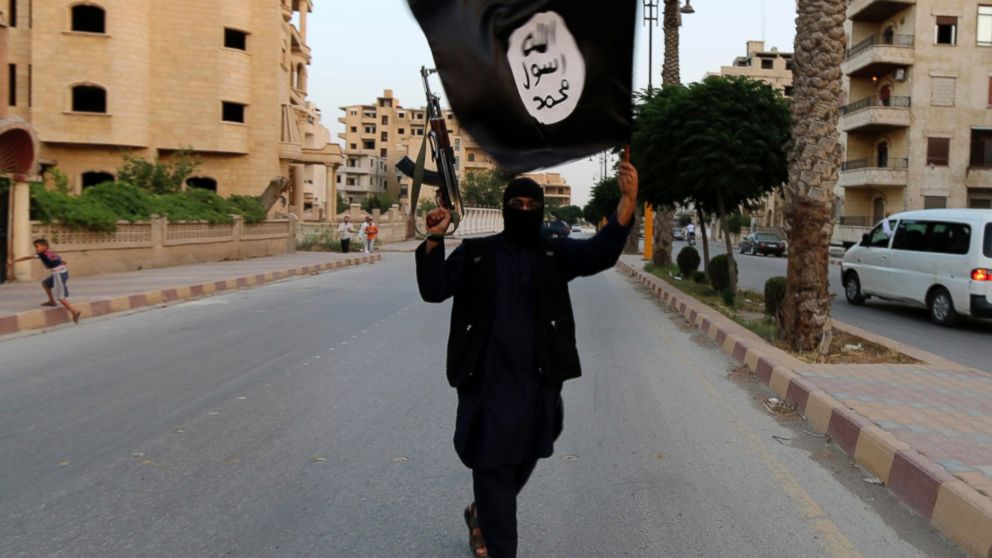 PHOTO: A member loyal to the Islamic State in Iraq and the Levant waves an ISIL flag in Raqqa, Syria in this June 29, 2014, file photo.