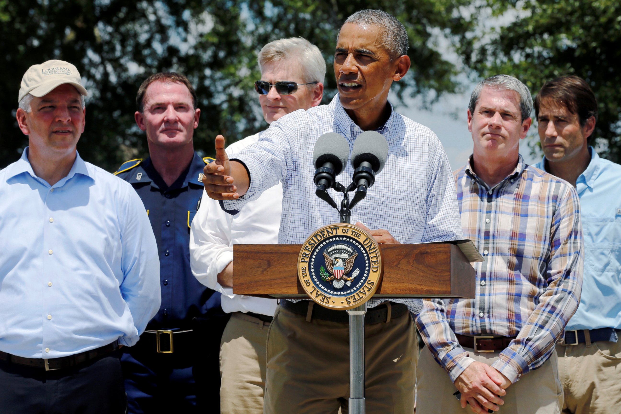 PHOTO: President Barack Obama  stands with elected officials including Louisiana Governor John Bel Edwards, left, delivers remarks after touring a flood-affected neighborhood in Zachary, Louisiana, Aug. 23, 2016.