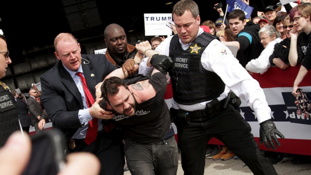U.S. Secret Service agents detain a man after a disturbance as Republican presidential candidate Donald Trump spoke at Dayton International Airport in Dayton, Ohio, March 12, 2016. 