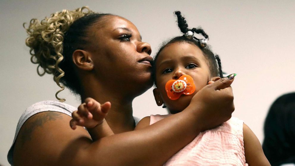 PHOTO: Tomika Miller, the wife of Rayshard Brooks, holds their daughter Memory, 2, during the family press conference, June 15, 2020, in Atlanta.