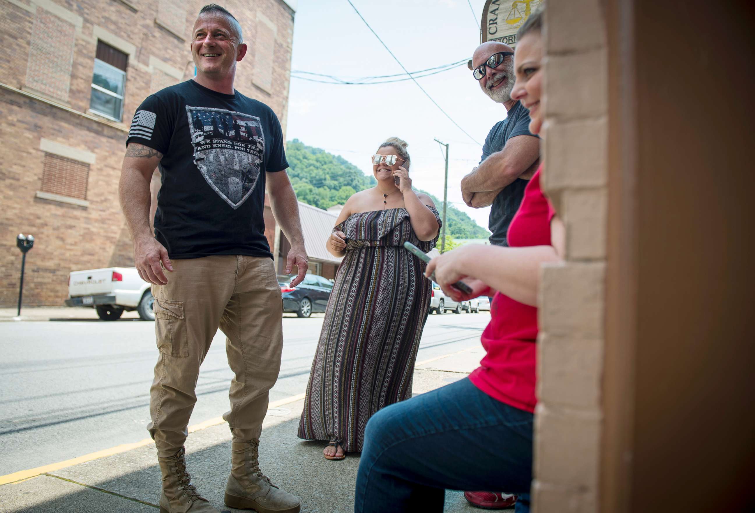PHOTO: Richard Ojeda, left, stands outside his campaign headquarters in Logan, West Virginia alongside his communications director Madalin Sammons, center, and campaign volunteer Heather Ritter, right, July 5, 2018.