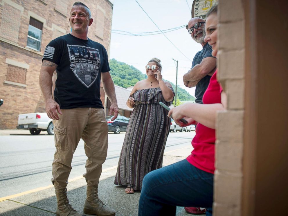 PHOTO: Richard Ojeda, left, stands outside his campaign headquarters in Logan, West Virginia alongside his communications director Madalin Sammons, center, and campaign volunteer Heather Ritter, right, July 5, 2018.