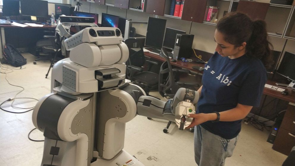 PHOTO: Roya Salek is seen here working with a robot in the socially assistive robotic lab. She is pursuing her PhD in Computer Science and Engineering at the University of Nevada, Reno.