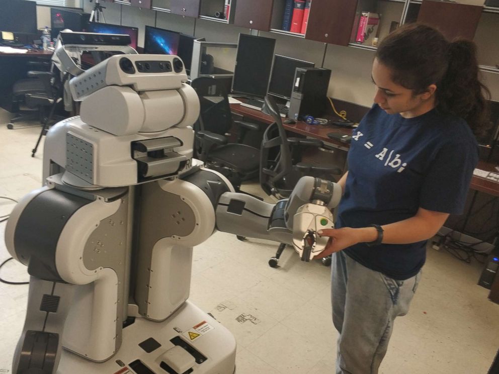 PHOTO: Roya Salek is seen here working with a robot in the socially assistive robotic lab. She is pursuing her PhD in Computer Science and Engineering at the University of Nevada, Reno.