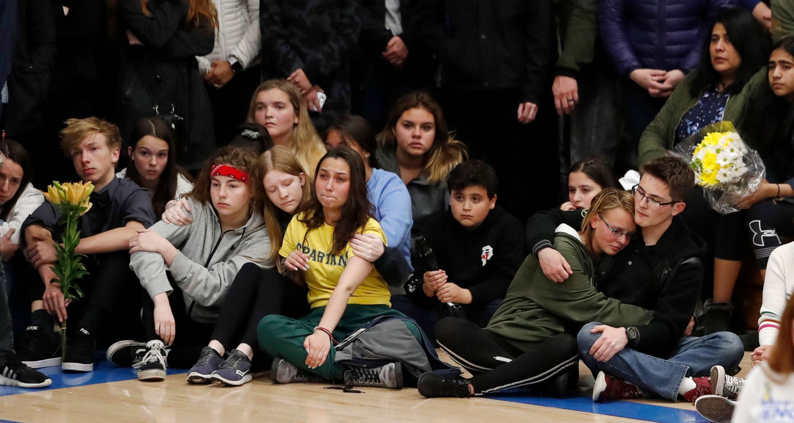 PHOTO: Young people console each other during a community vigil to honor the victims and survivors of a fatal shooting at the STEM School Highlands Ranch, late Wednesday, May 8, 2019, in Highlands Ranch, Colo.