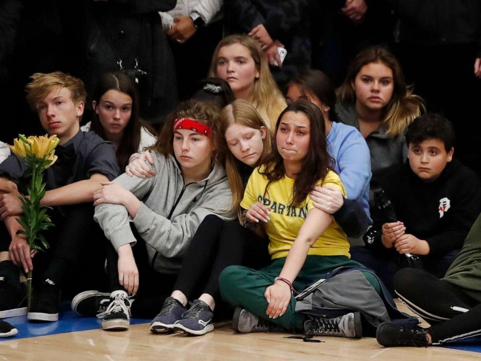 PHOTO: Young people console each other during a community vigil to honor the victims and survivors of a fatal shooting at the STEM School Highlands Ranch, late Wednesday, May 8, 2019, in Highlands Ranch, Colo.