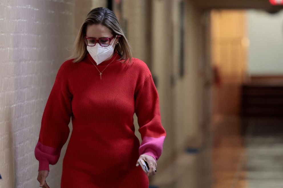 PHOTO: Sen. Kyrsten Sinema walks to her office in the basement of the Capitol Building, Jan. 19, 2022.