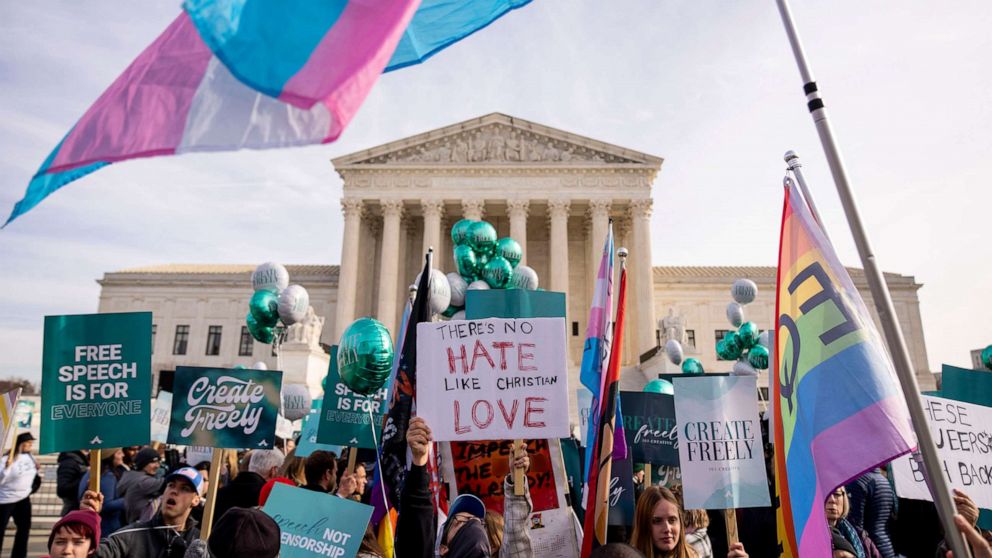 PHOTO: A person holds a sign that reads "There's No Hate Like Christian Love" as people on both sides of a debate rally outside the Supreme Court, Dec. 5, 2022. 