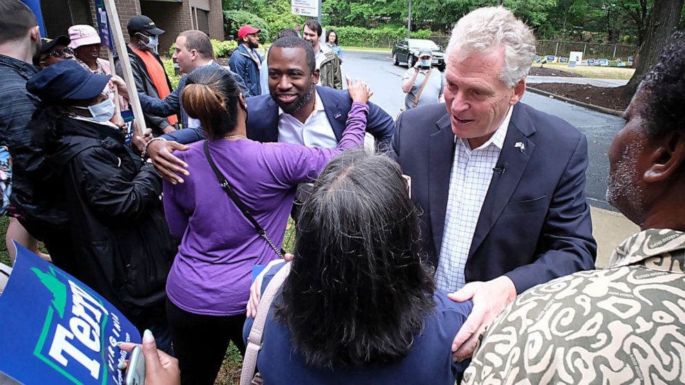 PHOTO: Former Virginia Gov. Terry McAuliffe, right, and Richmond Mayor Levar Stoney, left, greet McAuliffe supporters during a quick rally outside the Office of the General Registrar, in Richmond, Virginia, on  Friday, June 4, 2021.