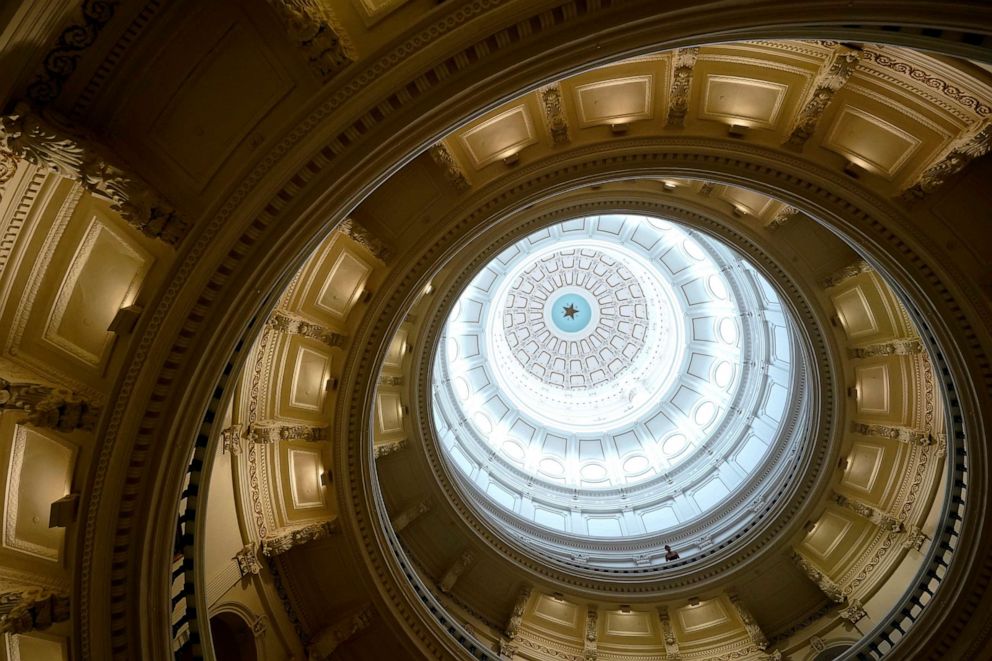 A visitor leans over a railing in the rotunda at the State Capitol on June 1, 2021, in Austin, Texas. The Texas Legislature closed out its regular session Monday.