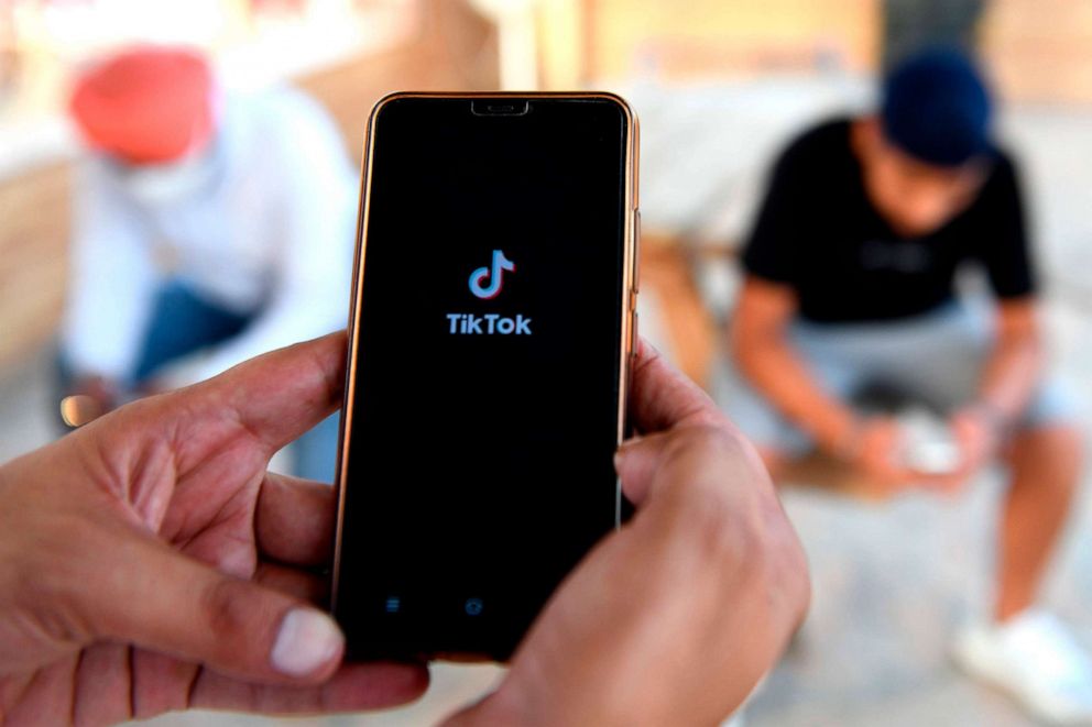 PHOTO: Smartphone users browse through the video-sharing app TikTok in Amritsar, India, June 30, 2020. 