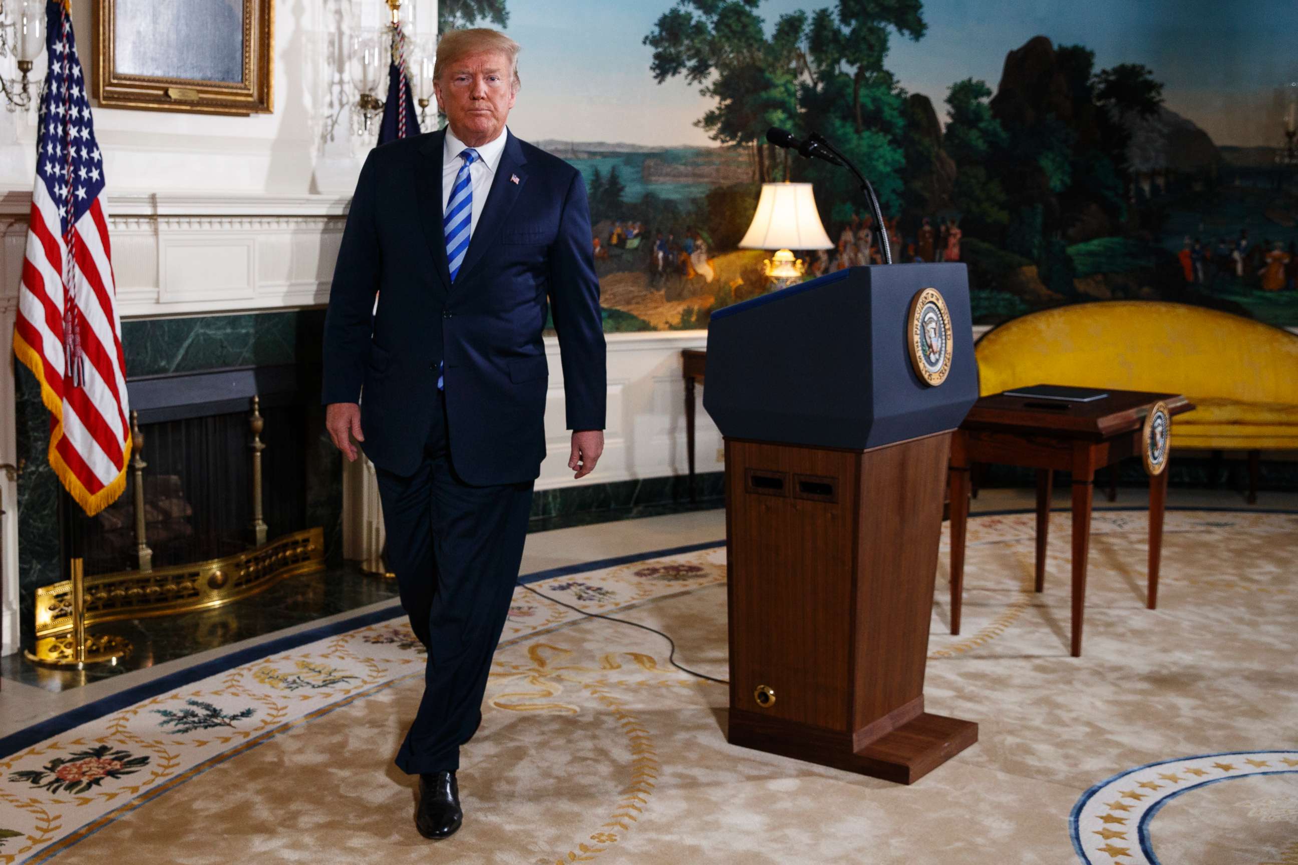 PHOTO: Donald Trump walks off after delivering a statement on the Iran nuclear deal from the Diplomatic Reception Room of the White House, May 8, 2018.
