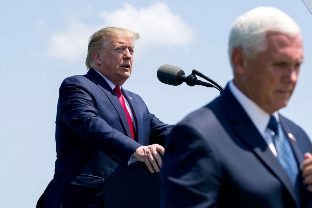 PHOTO: President Donald Trump speaks as Vice President Mike Pence walks to his seat during a full honors welcoming ceremony for Secretary of Defense Mark Esper at the Pentagon, July 25, 2019.