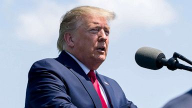 PHOTO: President Donald Trump speaks as Vice President Mike Pence walks to his seat during a full honors welcoming ceremony for Secretary of Defense Mark Esper at the Pentagon, July 25, 2019.