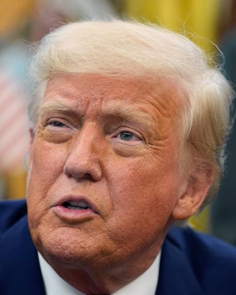 President Donald Trump speaks with reporters as he signs an executive order in the Oval Office of the White House, May 9, 2025.