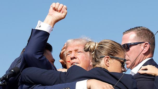 Former President Donald Trump is rushed offstage by Secret Service agents after being grazed by a bullet during a rally in Butler, Penn., July 13, 2024.