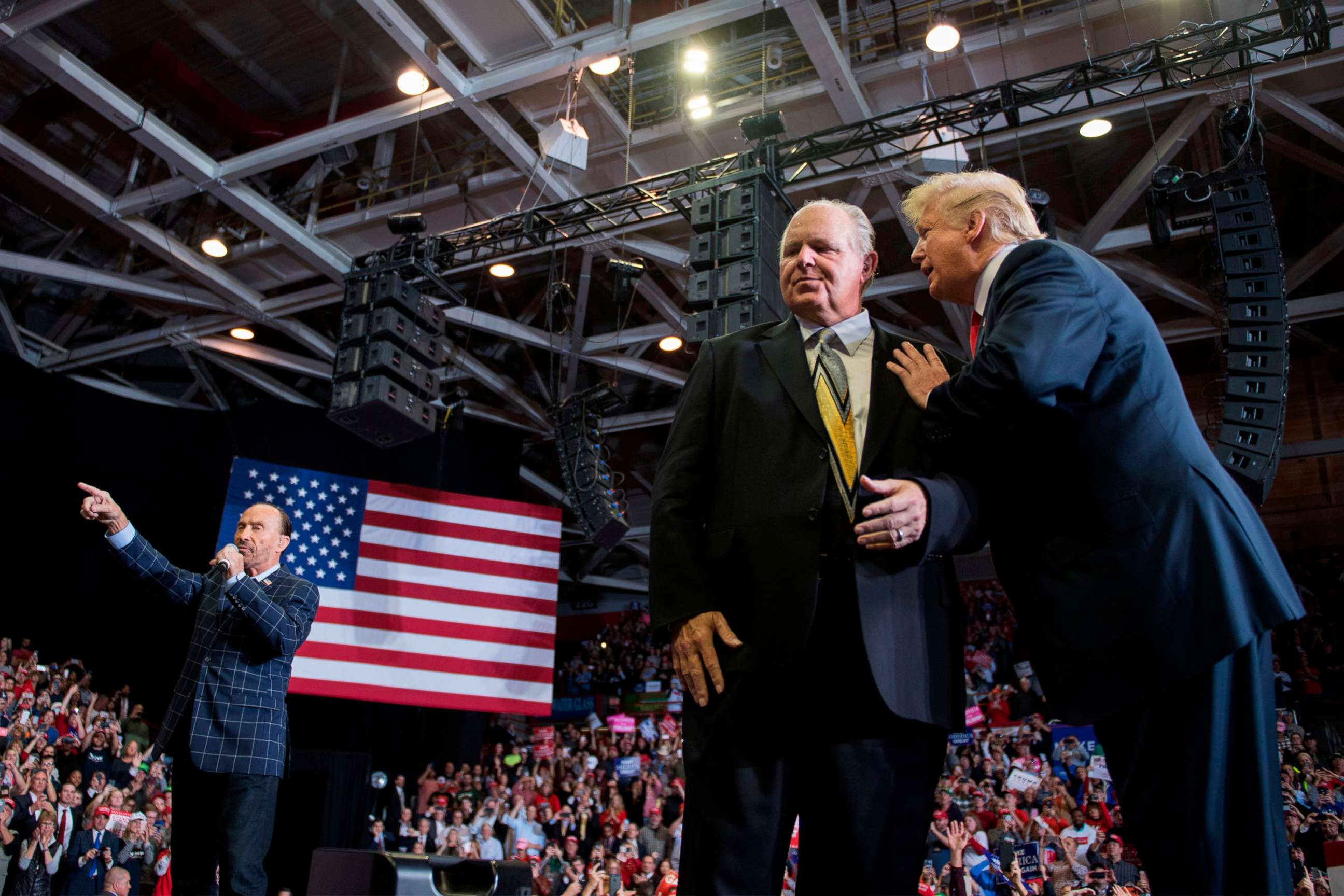 PHOTO: President Donald Trump speaks to radio talk show host Rush Limbaugh, while Lee Greenwood performs "God Bless The USA", at a Make America Great Again rally in Cape Girardeau, Mo., Nov. 5, 2018. 