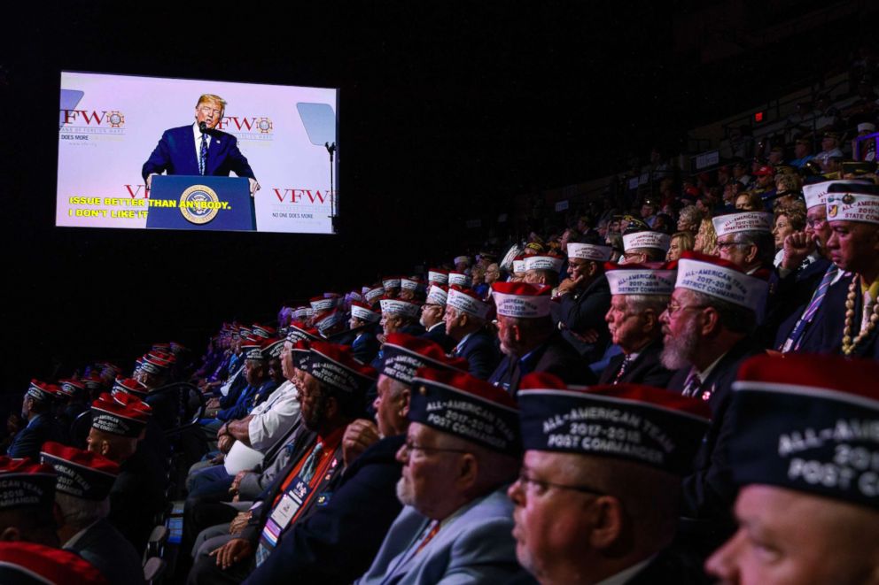 PHOTO: Audience members listen as President Donald Trump speaks during the Veterans of Foreign Wars of the United States National Convention,July 24, 2018, in Kansas City, Mo.
