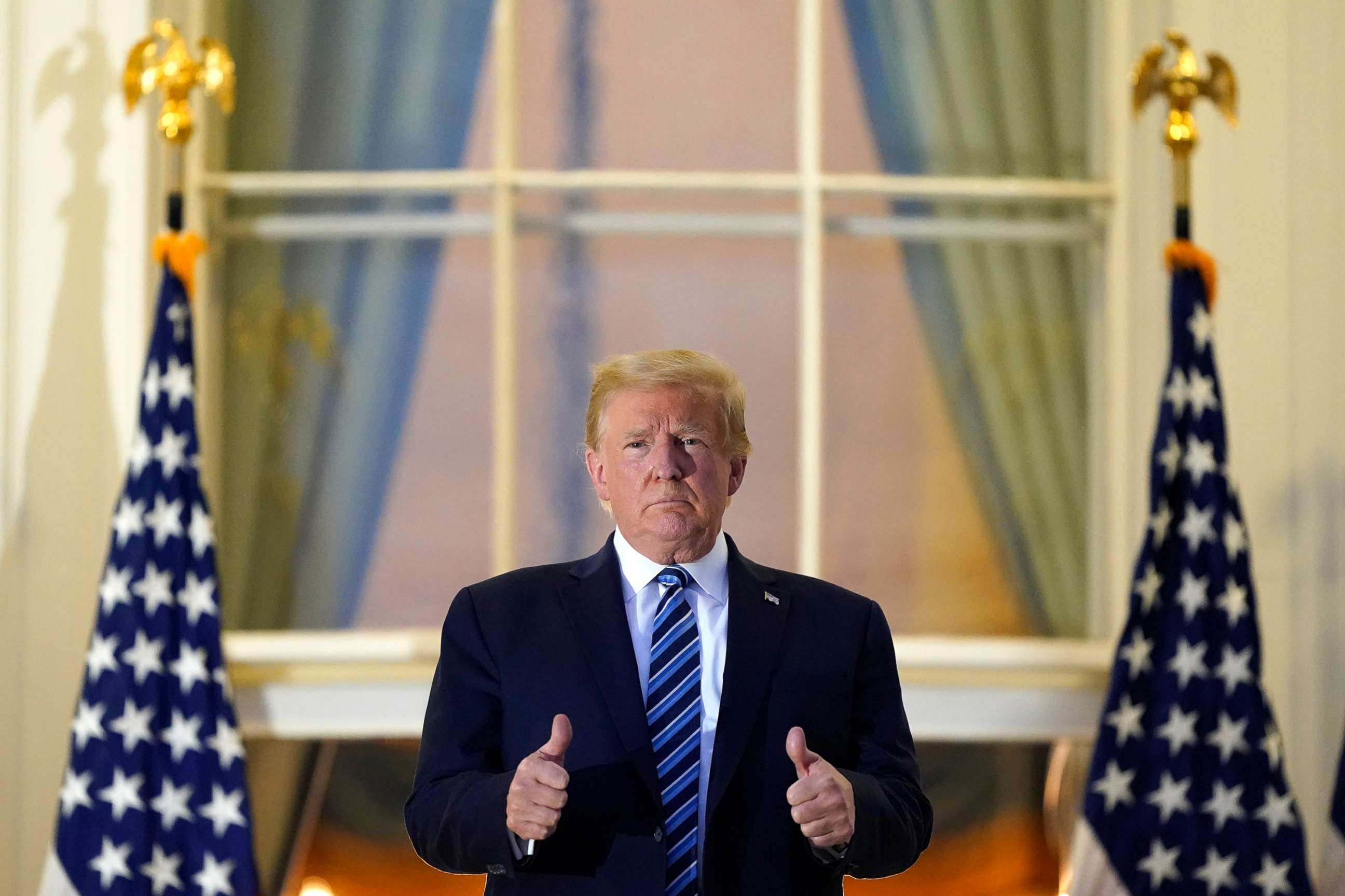 PHOTO: President Donald Trump stands on the balcony outside of the Blue Room as returns to the White House, Oct. 5, 2020, after leaving Walter Reed National Military Medical Center, in Bethesda, Md. 