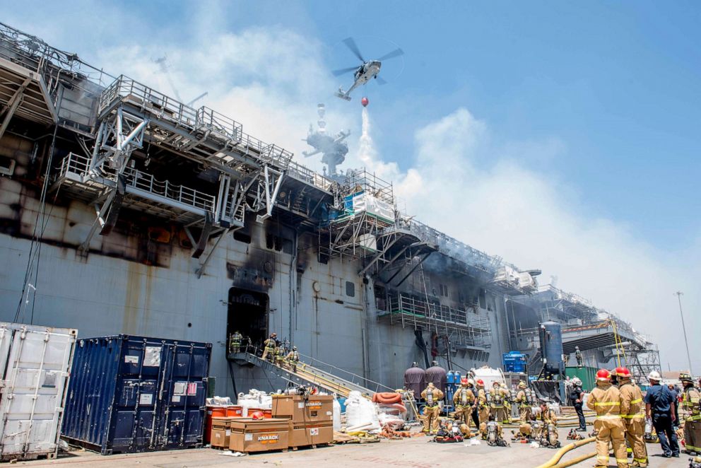 PHOTO: A helicopter from Helicopter Sea Combat Squadron helps combat a fire aboard the amphibious assault ship USS Bonhomme Richard, July 13, 2020, in San Diego.