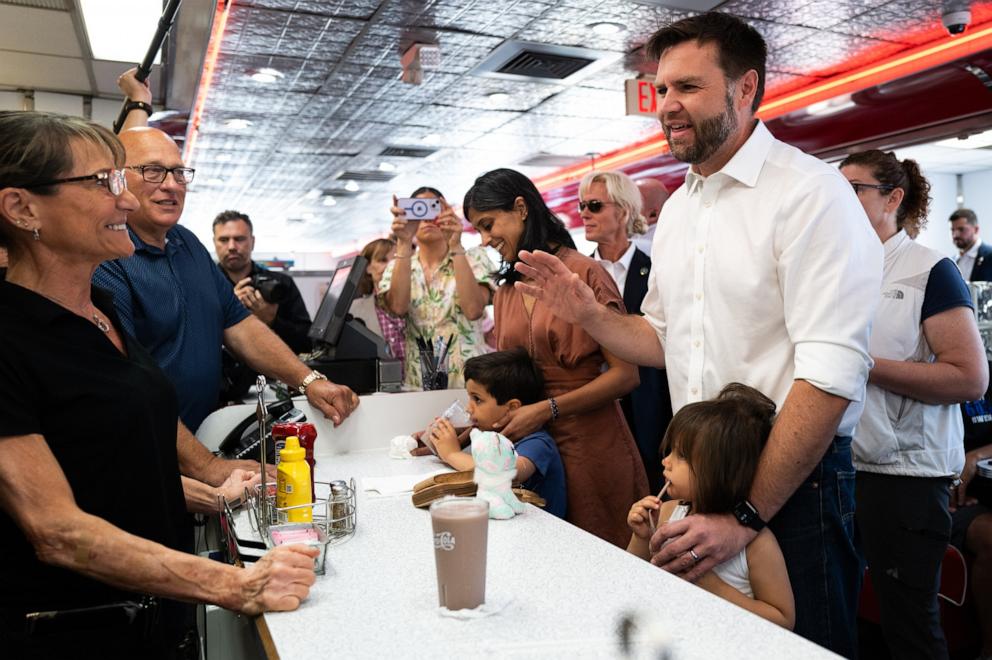 PHOTO: Republican vice presidential nominee Sen. J.D. Vance and his family greet supporters at the Park Diner in St. Cloud, MN, July 28, 2024.