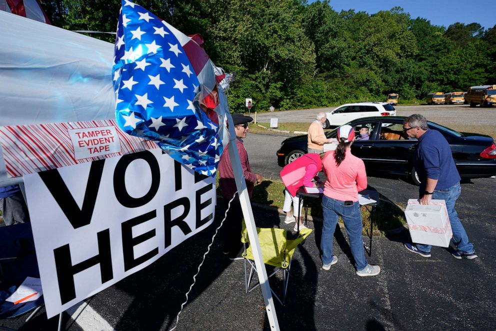 Convention workers collect ballots during a drive-through GOP Convention vote in Chesterfield, Virginia on May 8, 2021. 