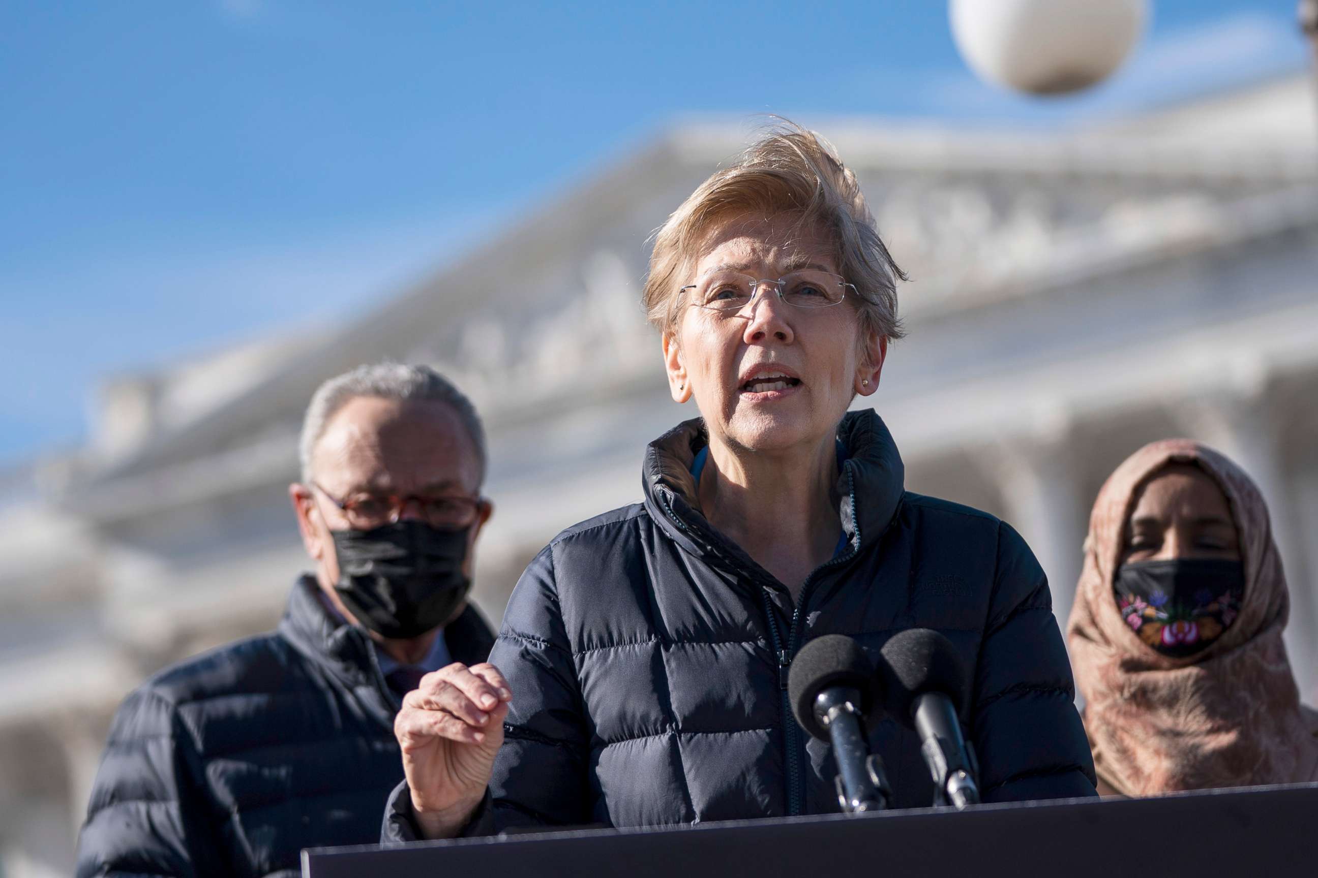 PHOTO: Flanked by Senate Majority Leader Chuck Schumer and Rep. Ilhan Omar, Sen. Elizabeth Warren speaks during a press conference about student debt outside the Capitol, Feb. 4, 2021.