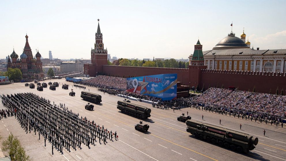 FILE - Russian military vehicles roll down Red Square Red Square during a rehearsal for the Victory Day military parade in Moscow, Russia, on May 7, 2019. Some in the West think Russian President Vladimir Putin may use the Victory Day on May 9 when R