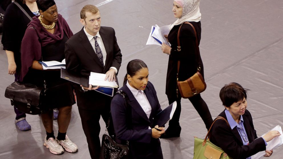 FILE - Job hunters line up for interviews at an employment fair sponsored by the New York State Department of Labor, Wednesday, Oct. 8, 2014 in the Brooklyn borough of New York. Just four months ago, city lawmakers overwhelmingly voted to require man