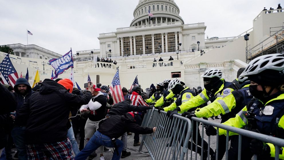FILE - Insurrectionists loyal to President Donald Trump try to break through a police barrier, Wednesday, Jan. 6, 2021, at the Capitol in Washington. Facing prison time and dire personal consequences for storming the U.S. Capitol, some Jan. 6 defenda
