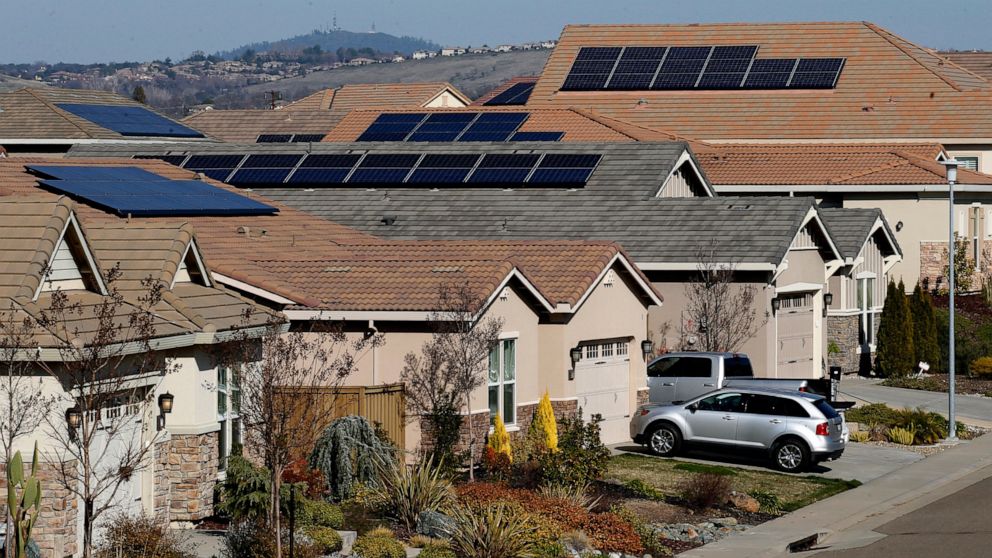 FILE—Solar panels sit on rooftops at a housing development in Folsom, Calif., Wednesday, Feb. 12, 2020. California regulators on Thursday, Nov 10, 2022 proposed changes to the state's residential solar market aimed at encouraging more at-home battery