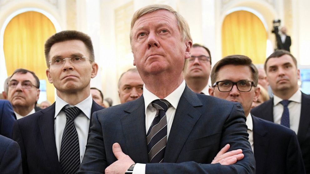 FILE - Rosnano Chairman Anatoly Chubais, center, attends the inauguration of Russian President Vladimir Putin in the Kremlin's Grand Kremlin Palace in Moscow, Russia, Monday, May 7, 2018. Chubais, who resigned as a high-ranking adviser to Russian Pre