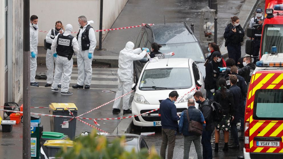 FILE - In this Sept. 25, 2020 file photo, police and forensic investigate an attack that wounded two people near the former offices of the satirical newspaper Charlie Hebdo, in Paris, France. French lawmakers tackle a bill on Monday to dig up radical