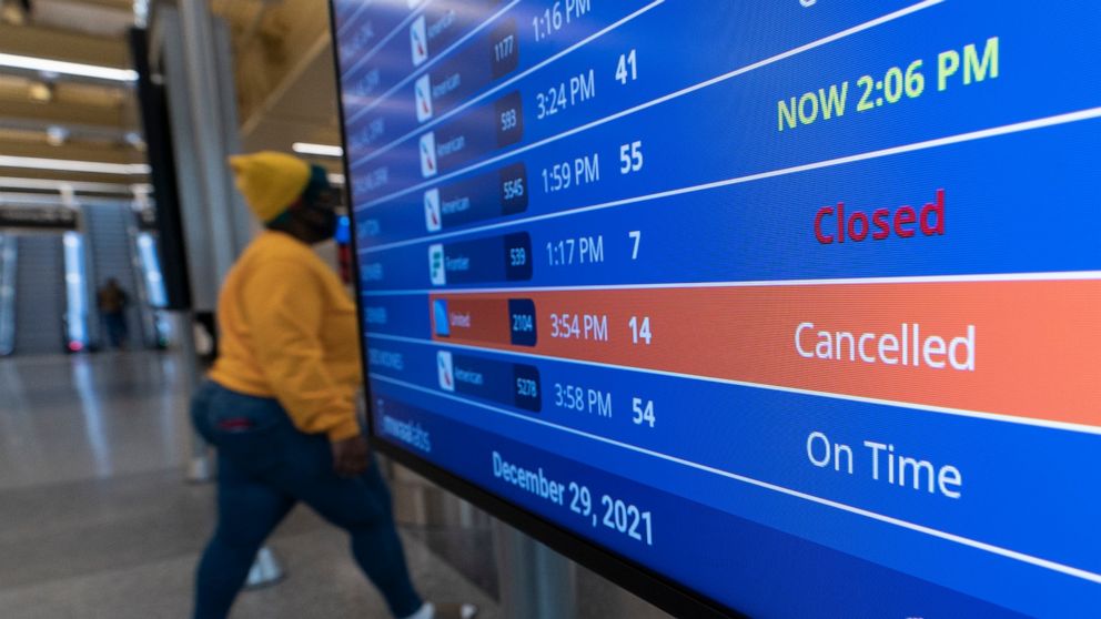 FILE - A flight shows cancelled on the departures board at Ronald Reagan Washington National Airport, Wednesday, Dec. 29, 2021, in Arlington, Va. The Transportation Department is proposing to require airlines to offer passengers a refund if their fli